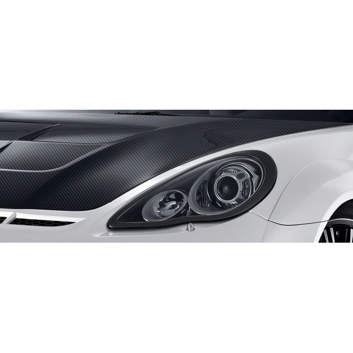 Modify your Porsche Panamera 2010 with our Lighting/Headlight and Tail Light Covers - Angled view of the carbon fiber hood and headlight