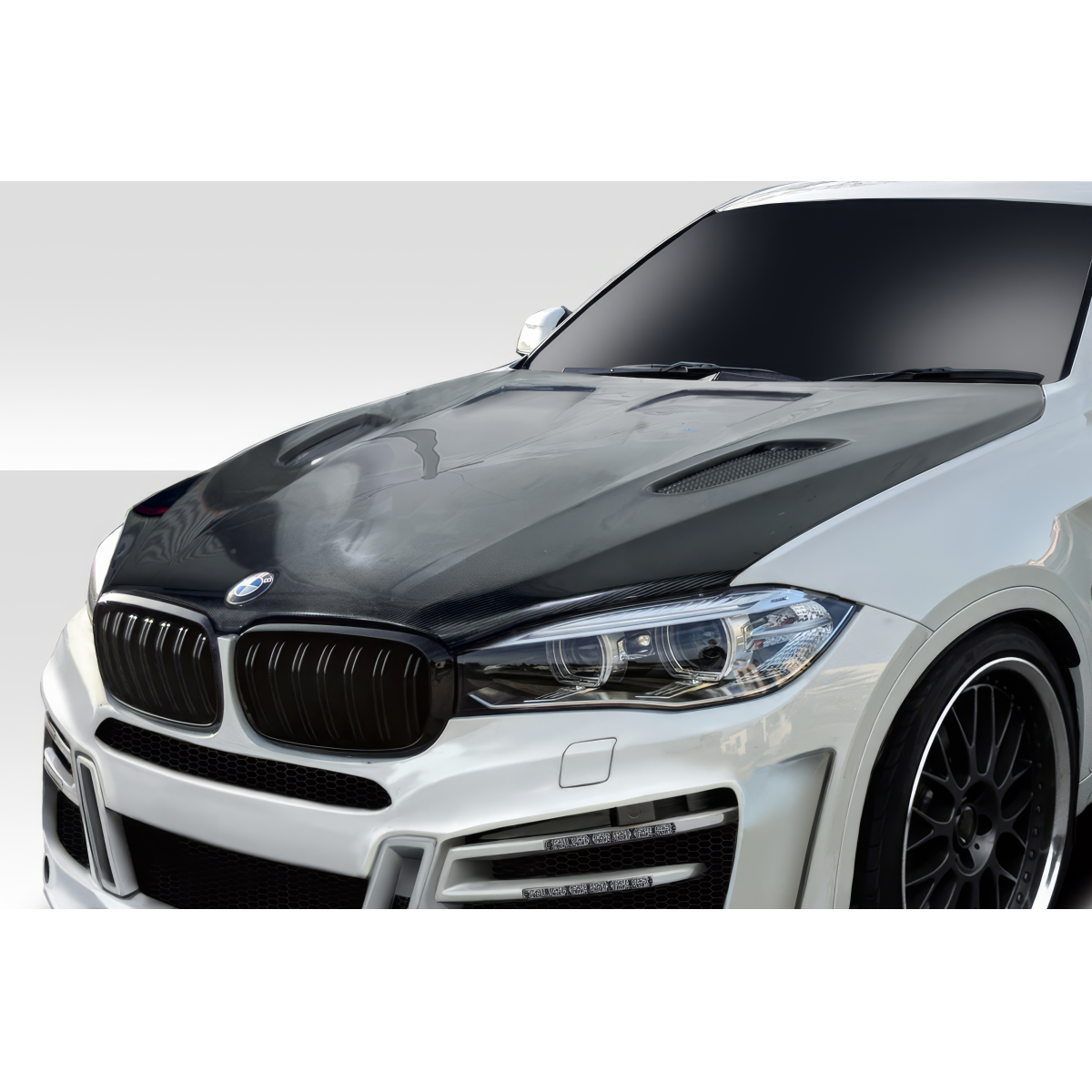 Modify your BMW X6 2015 with our Exterior/Hoods - Front angle showcasing the carbon fiber hood