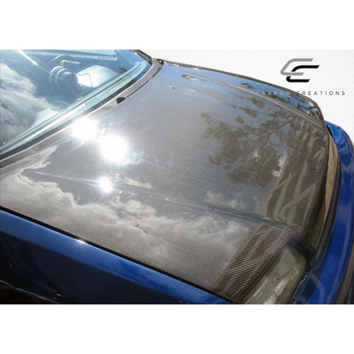 Modify your Honda Civic 1988 with our Exterior/Hoods - Top view of a carbon fiber hood at a slight angle