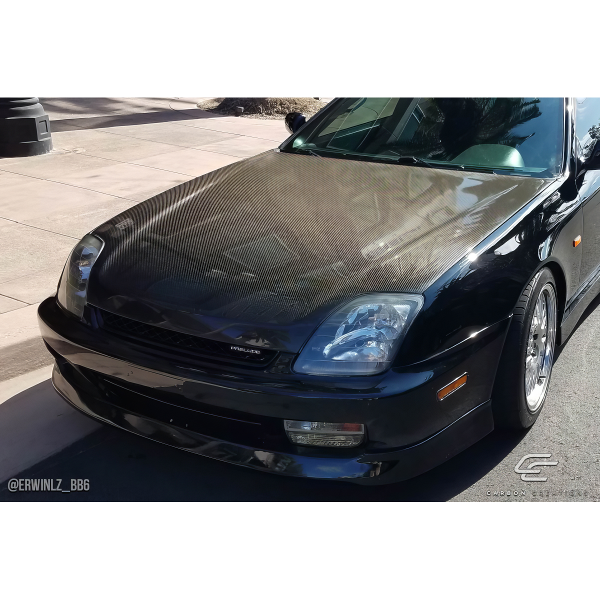 Modify your Honda Prelude 1997 with our Exterior/Hoods - Front angle view of a carbon fiber hood