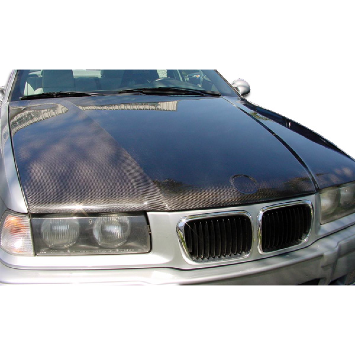 Modify your BMW 3-Series 1992 with our Exterior/Hoods - Front view of a carbon fiber hood on a BMW