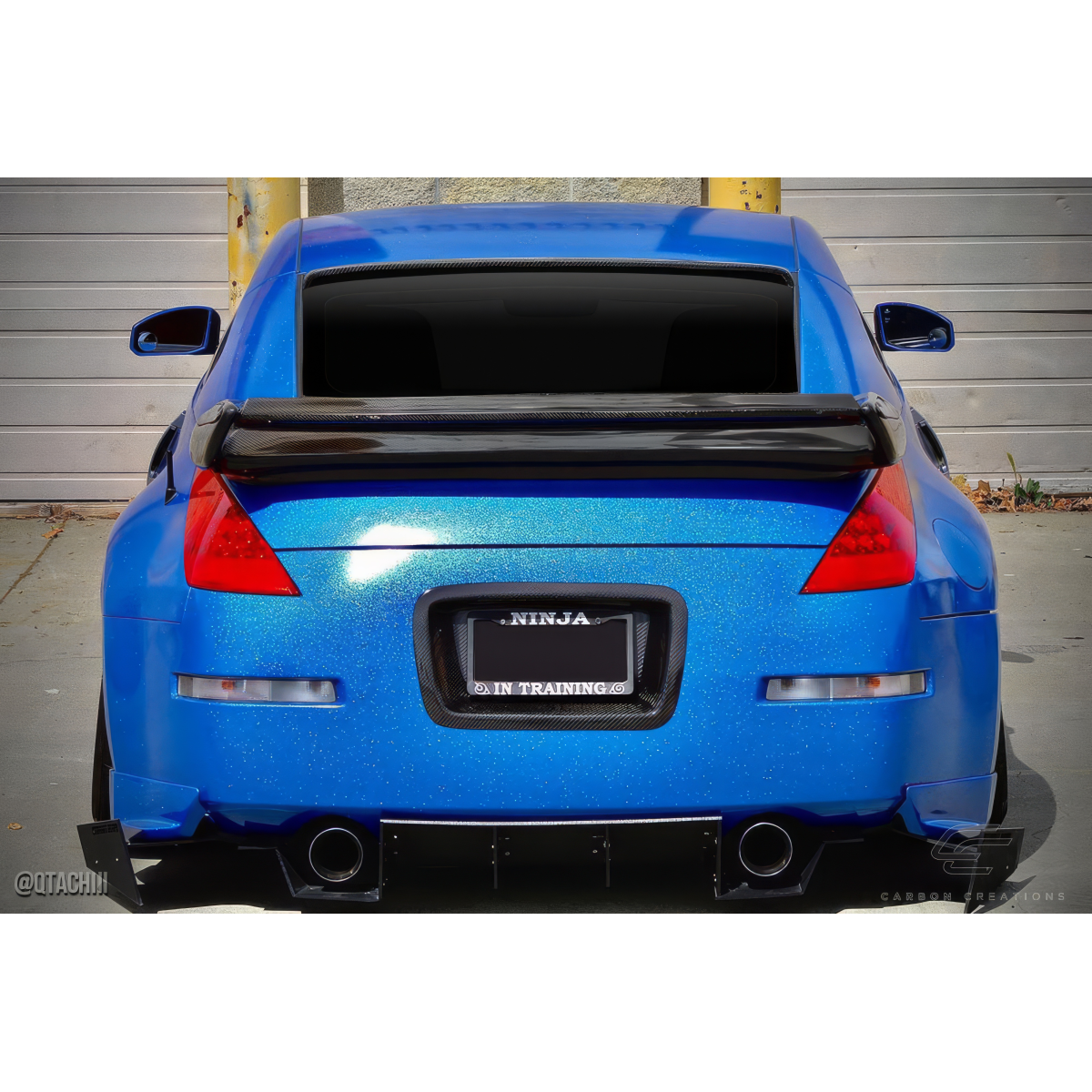 Modify your Nissan 350Z 2003 with our Exterior/Wings - Rear view angle displaying the carbon fiber wing