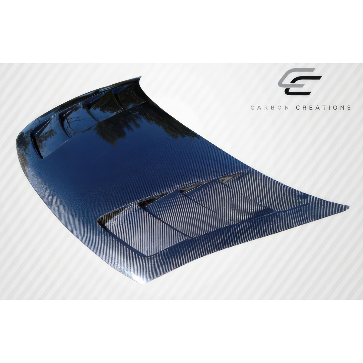 Modify your Honda Civic 2006 with our Exterior/Hoods - Angled view of carbon fiber hood in sunlight