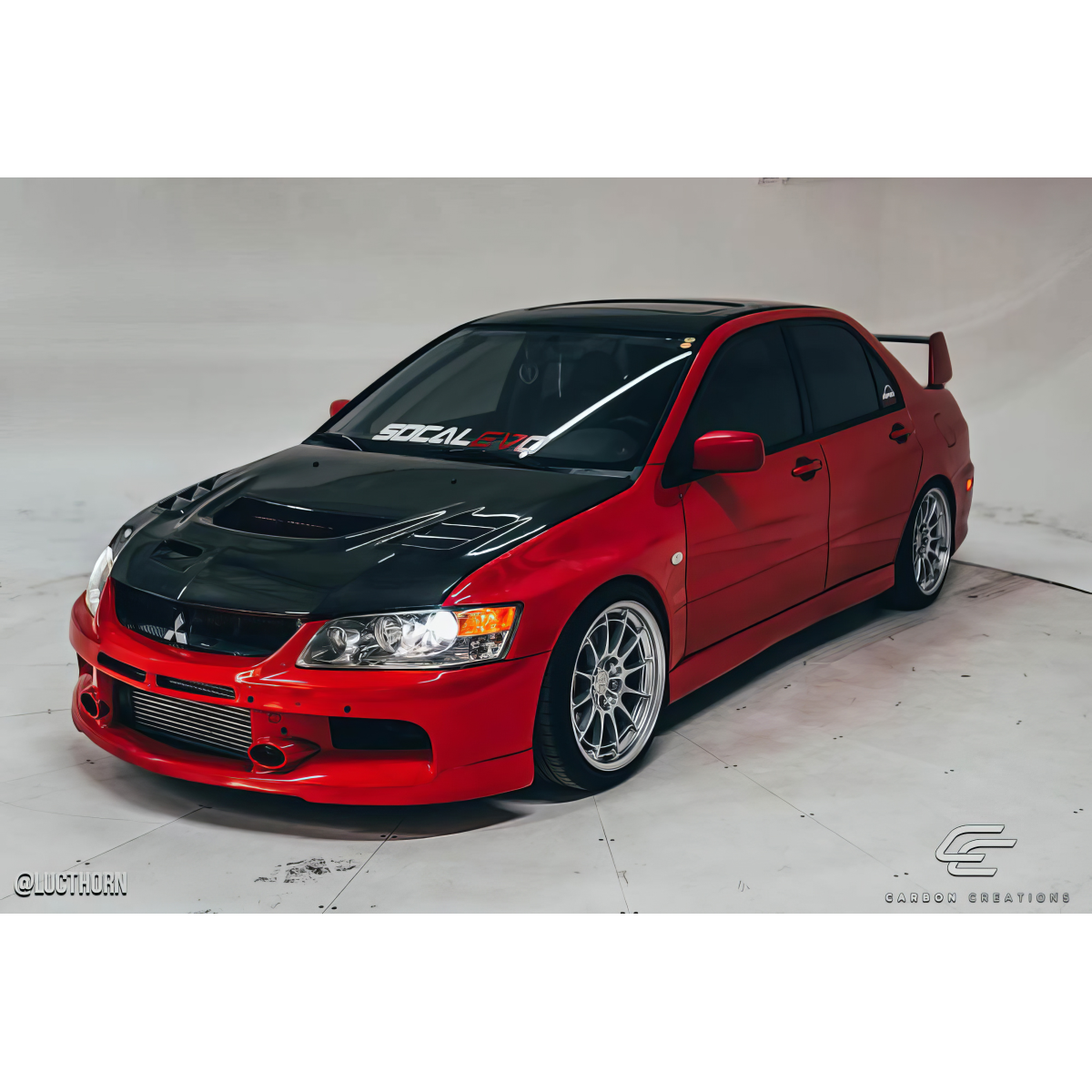 Modify your Mitsubishi Evolution 2003 with our Exterior/Hoods - Front angle view of modified car hoods