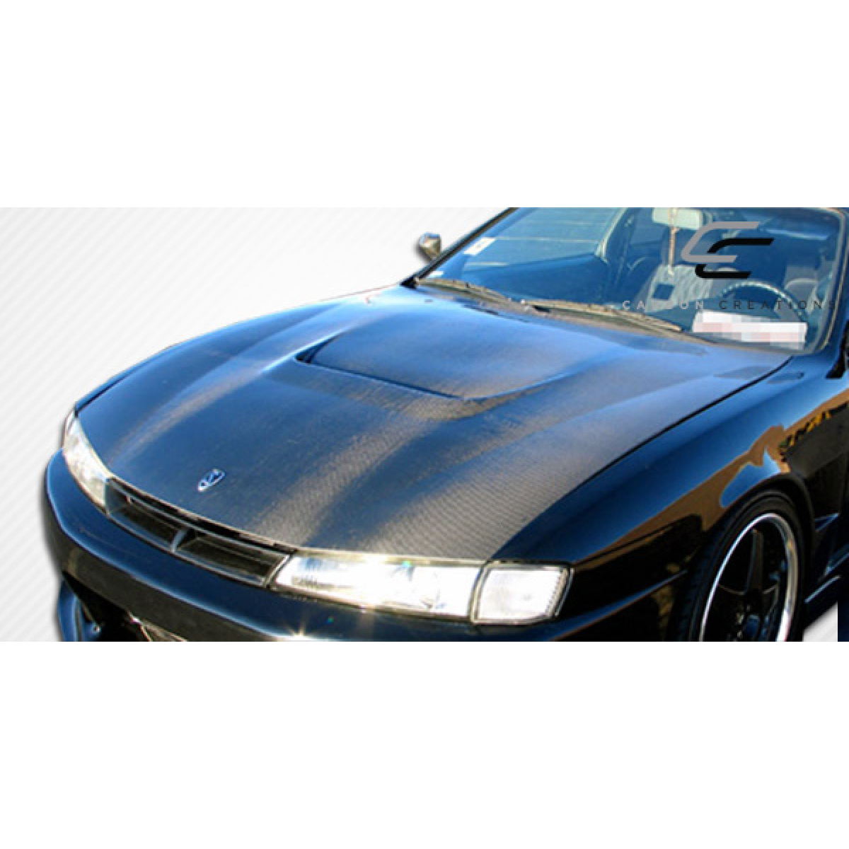 Modify your Nissan 240SX 1997 with our Exterior/Hoods - Front angle view of carbon fiber hood