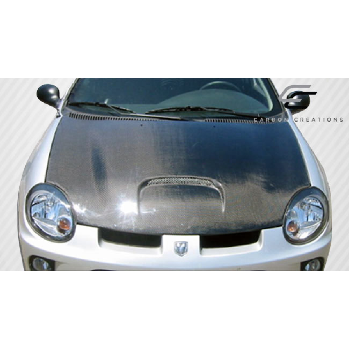 Modify your Dodge Neon 2000 with our Exterior/Hoods - Front view of the hood at a slight angle