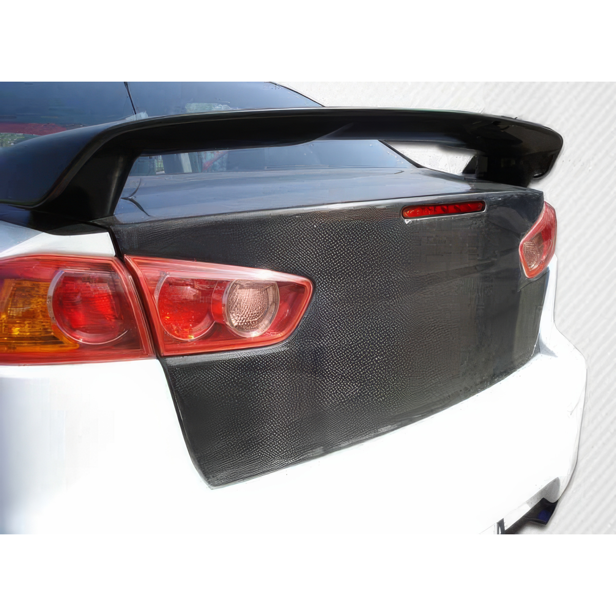 Modify your Mitsubishi Evolution 2008 with our Exterior/Trunks - Rear view angle showing carbon fiber trunk