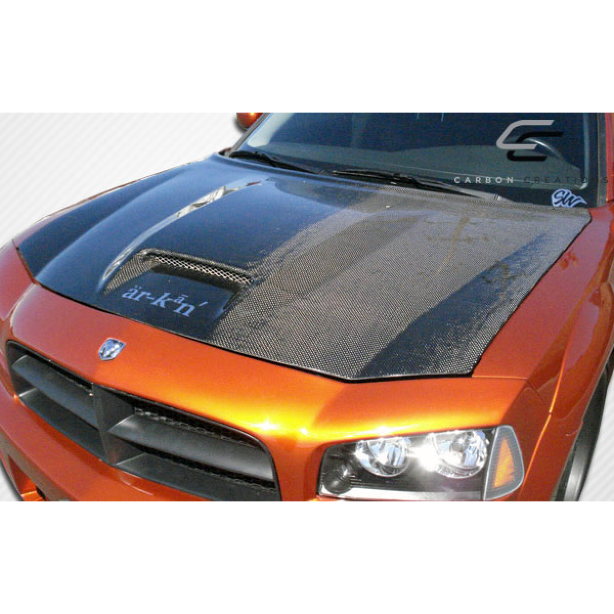 Modify your Dodge Charger 2006 with our Exterior/Hoods - Partial front view of the hood at a slight angle