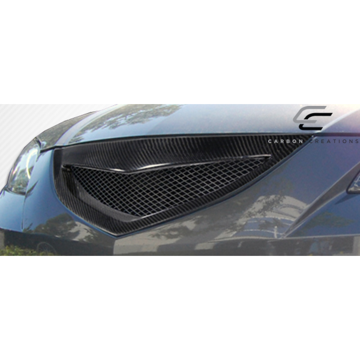 Modify your Mazda 3 2004 with our Exterior/Grilles - Front view of carbon fiber grille at slight angle