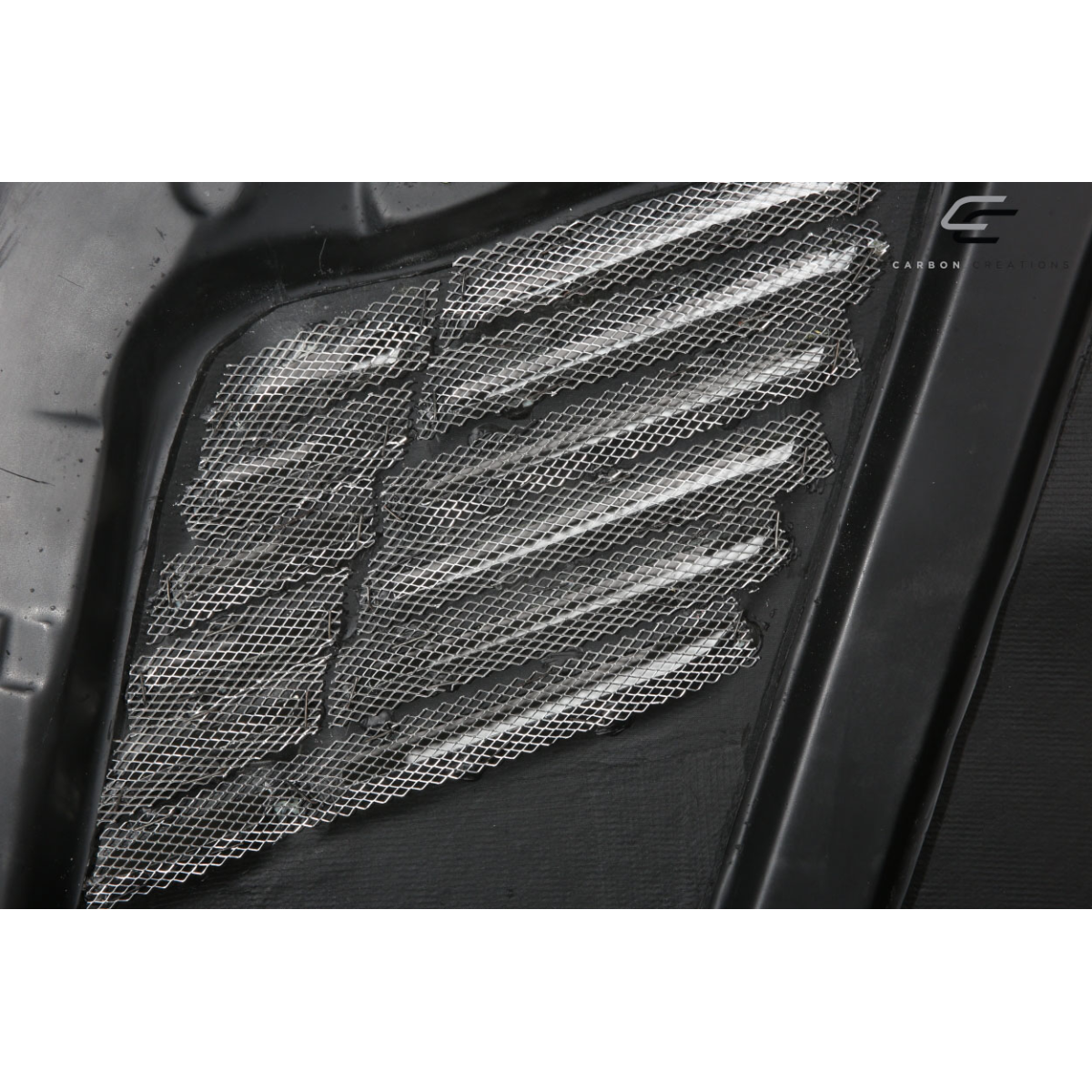 Modify your BMW 5-Series 2004 with our Exterior/Hoods - Angled view showing carbon fiber texture and mesh