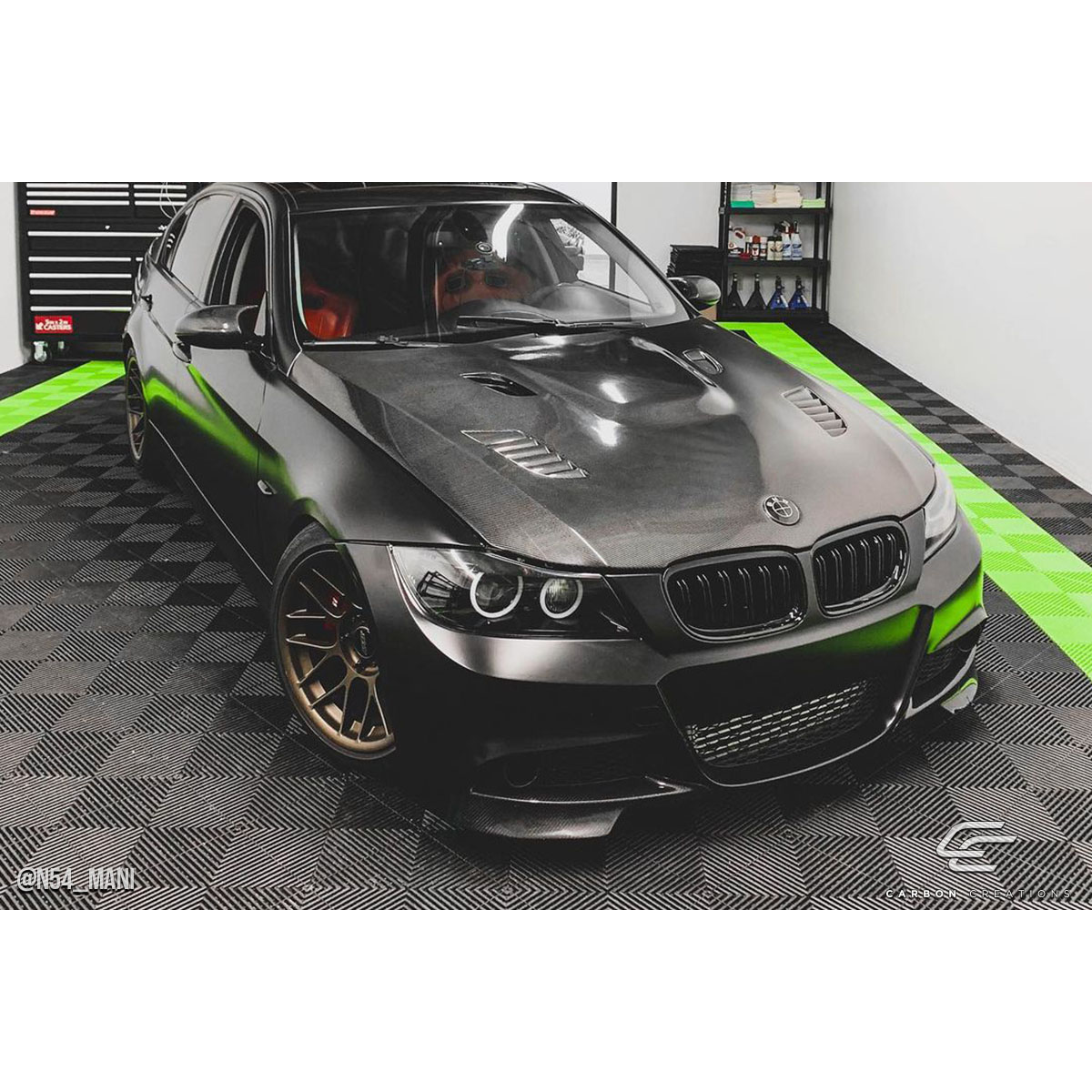 Modify your BMW 3-Series 2009 with our Exterior/Hoods - Front angled view of the vehicle showing details