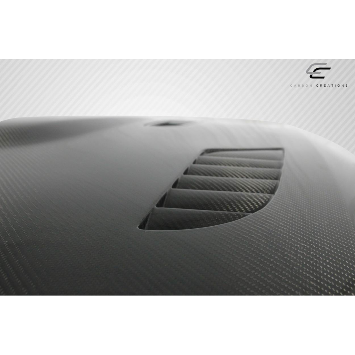 Modify your BMW 3-Series 2009 with our Exterior/Hoods - View from a slight angle showing carbon fiber hood details