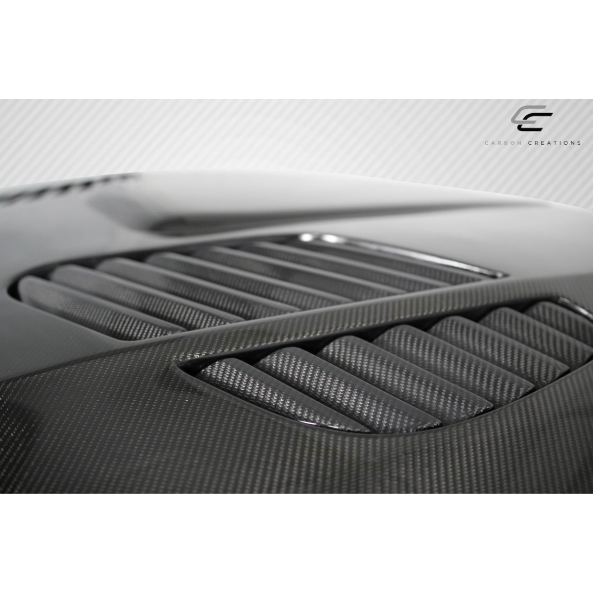 Modify your BMW M3 2008 with our Exterior/Hoods - Angled view of carbon fiber hood at close range