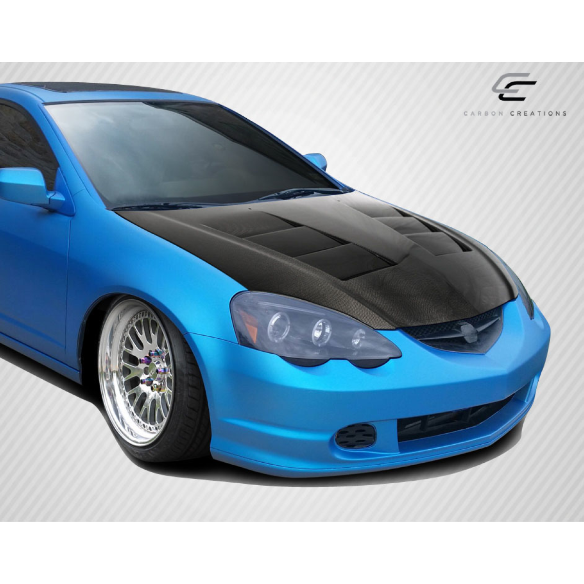 Modify your Acura RSX 2002 with our Exterior/Hoods - Angled view of blue Acura RSX with carbon fiber hood