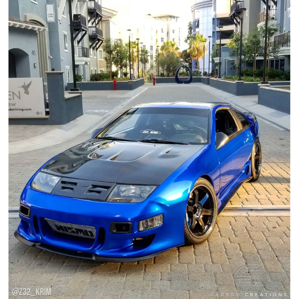 Modify your Nissan 300ZX 1990 with our Exterior/Hoods - Front angle view of a blue Nissan 300ZX
