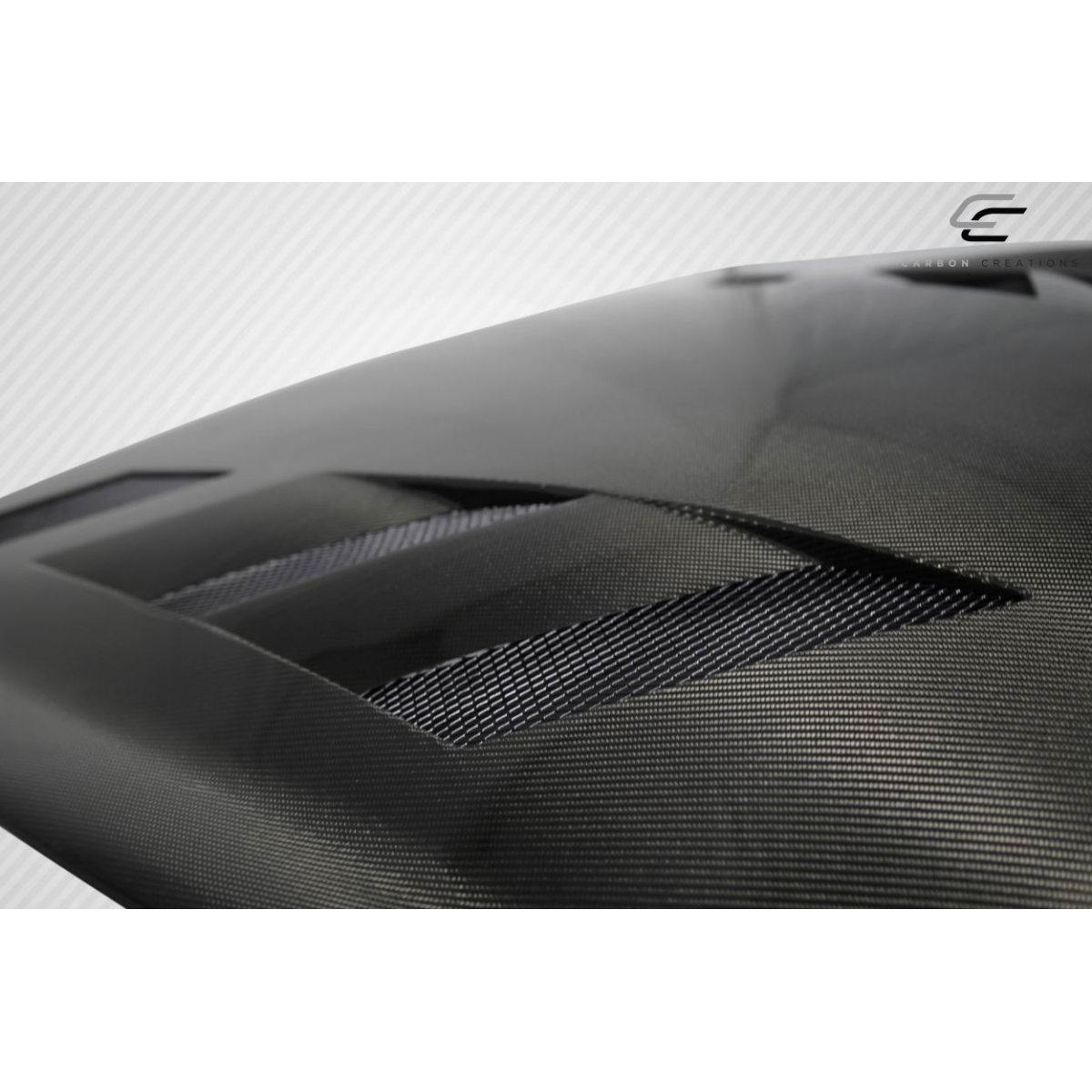 Modify your Infiniti G37 2008 with our Exterior/Hoods - Angled view of carbon fiber hood with vents