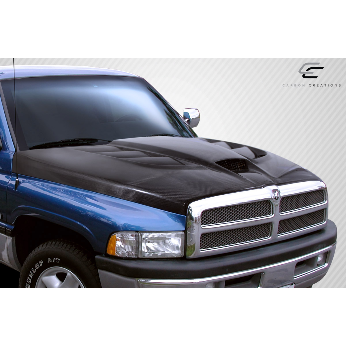 Modify your Dodge Ram 1994 with our Exterior/Hoods - Front angled view of the carbon fiber hood