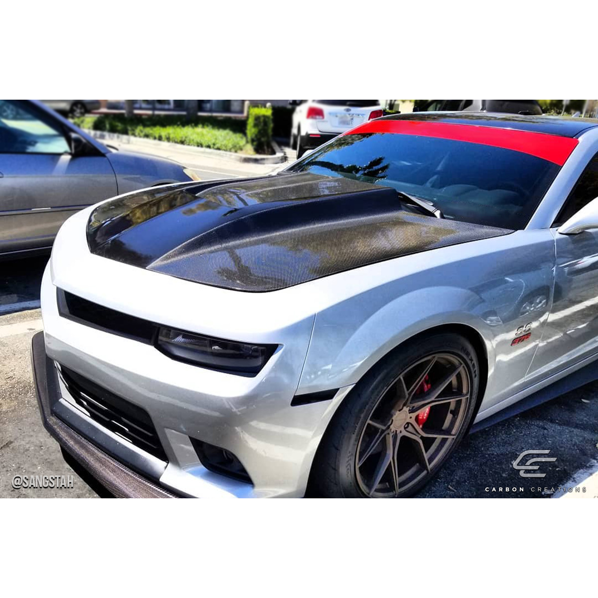 Modify your Chevrolet Camaro 2010 with our Exterior/Hoods - Front angle highlighting carbon fiber hood