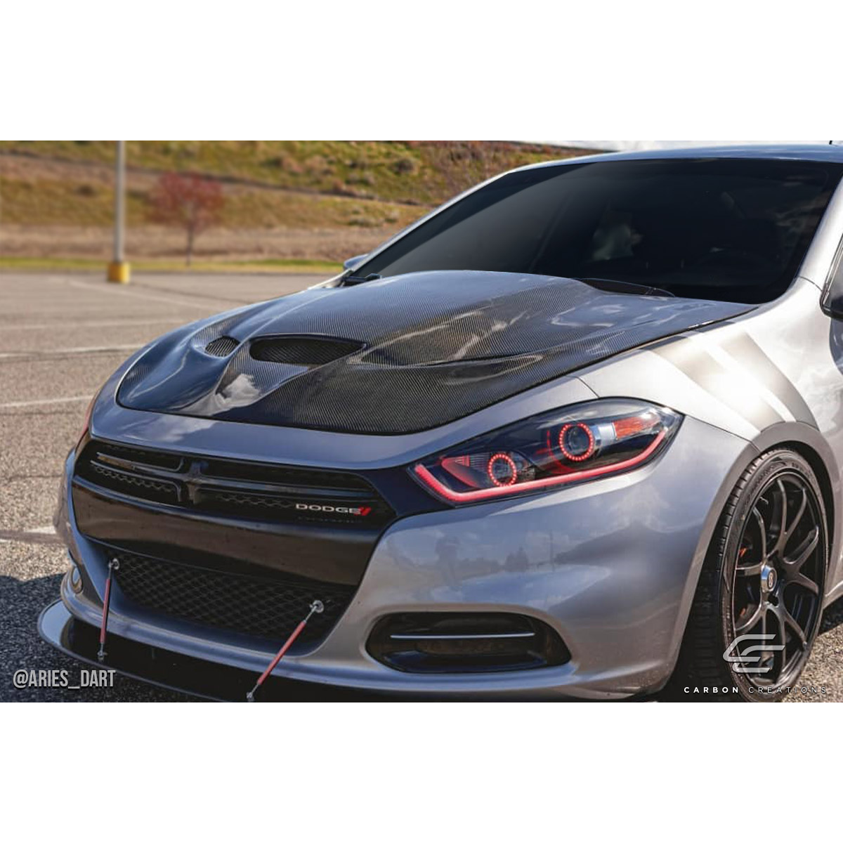 Modify your Dodge Dart 2013 with our Exterior/Hoods - Front view of vehicle at a slight angle