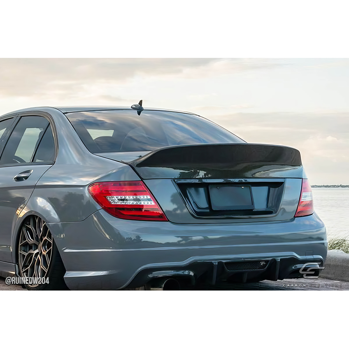 Modify your Mercedes-Benz C300 2008 with our Exterior/Wings - Rear angle showcasing carbon fiber wing design