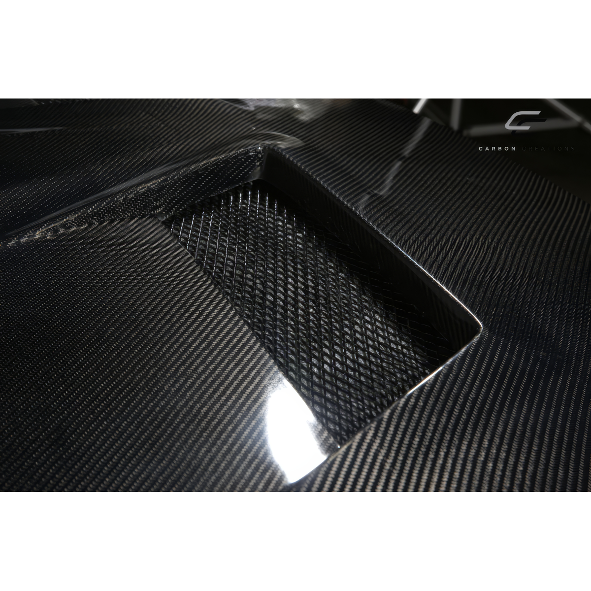 Modify your Mitsubishi Evolution 2008 with our Exterior/Hoods - Close-up angle showcasing carbon fiber texture