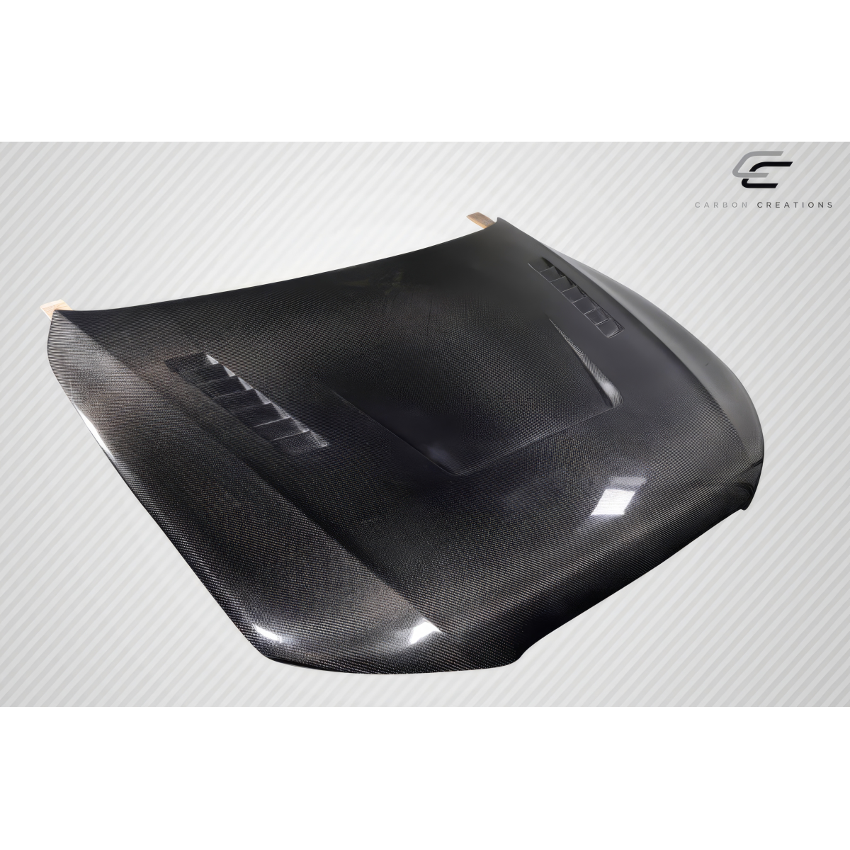 Modify your Audi A5 2013 with our Exterior/Hoods - Angled view of a carbon fiber hood