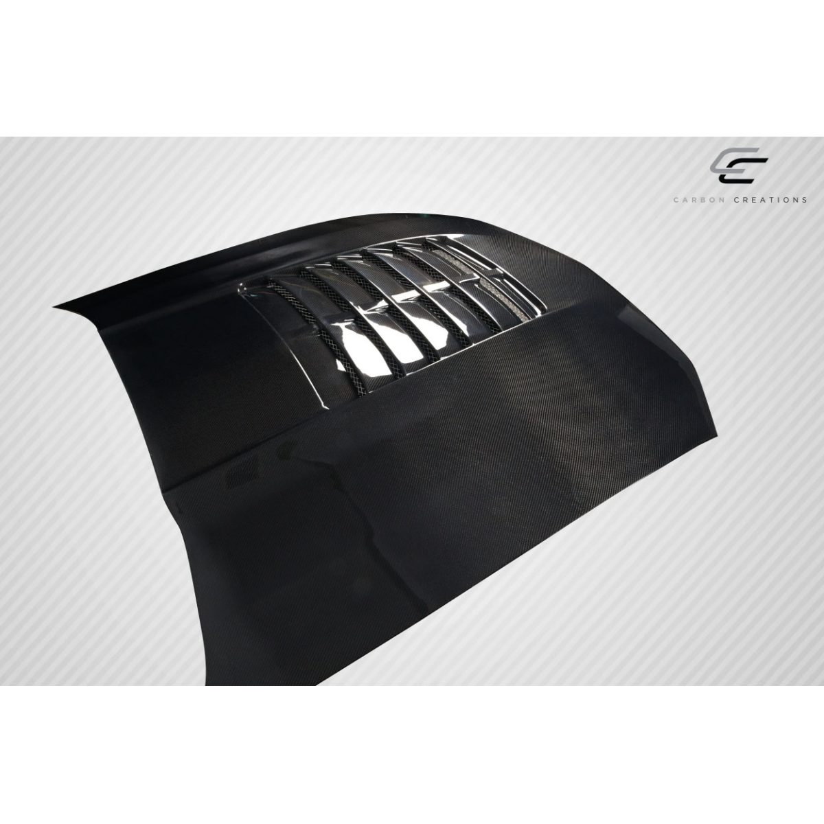 Modify your Ford Mustang 2005 with our Exterior/Hoods - Angled view of a carbon fiber hood part