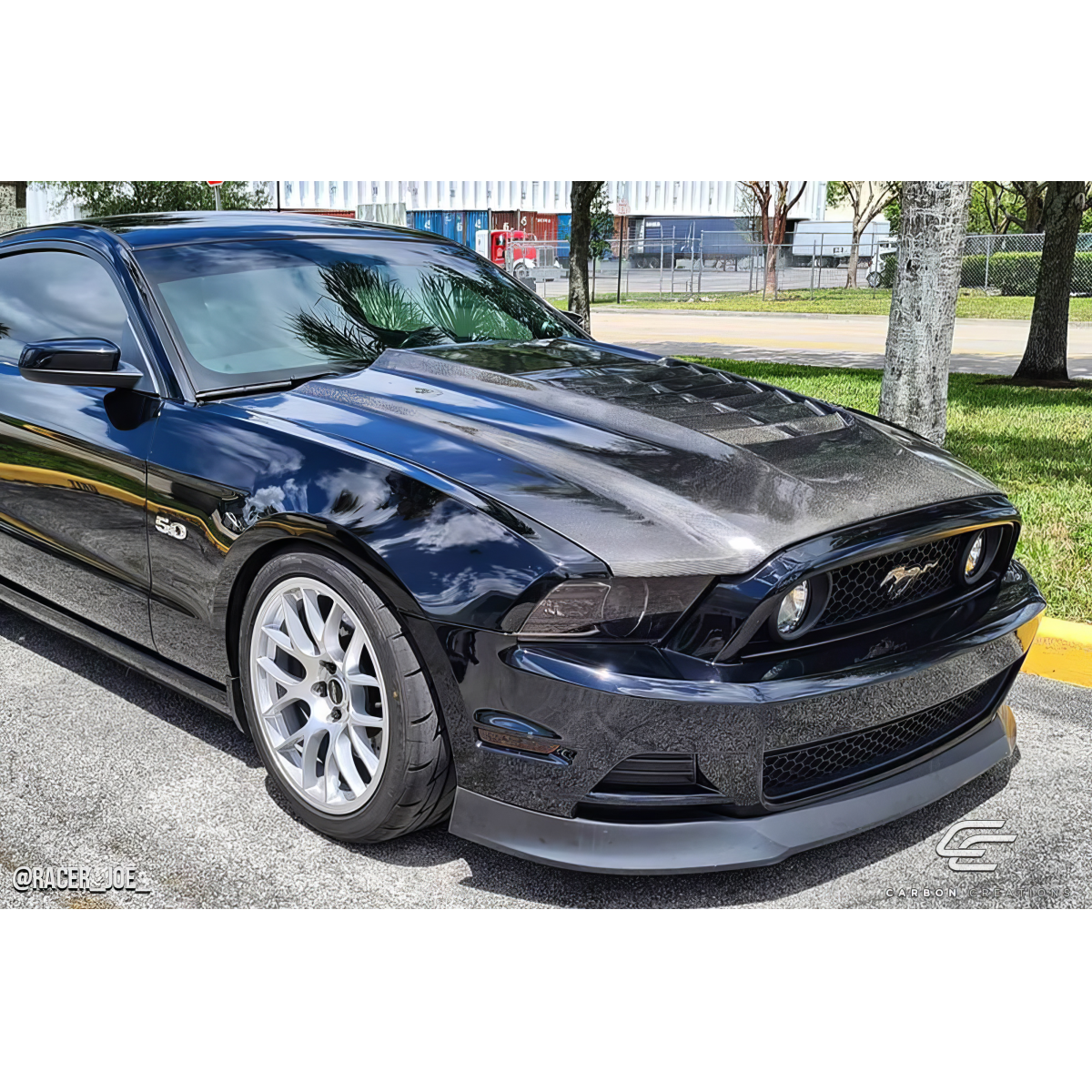 Modify your Ford Mustang 2013 with our Exterior/Hoods - Front angle view of the car showing the hood