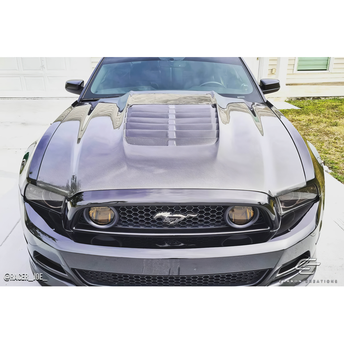 Modify your Ford Mustang 2013 with our Exterior/Hoods - Front view of the car at a slight angle