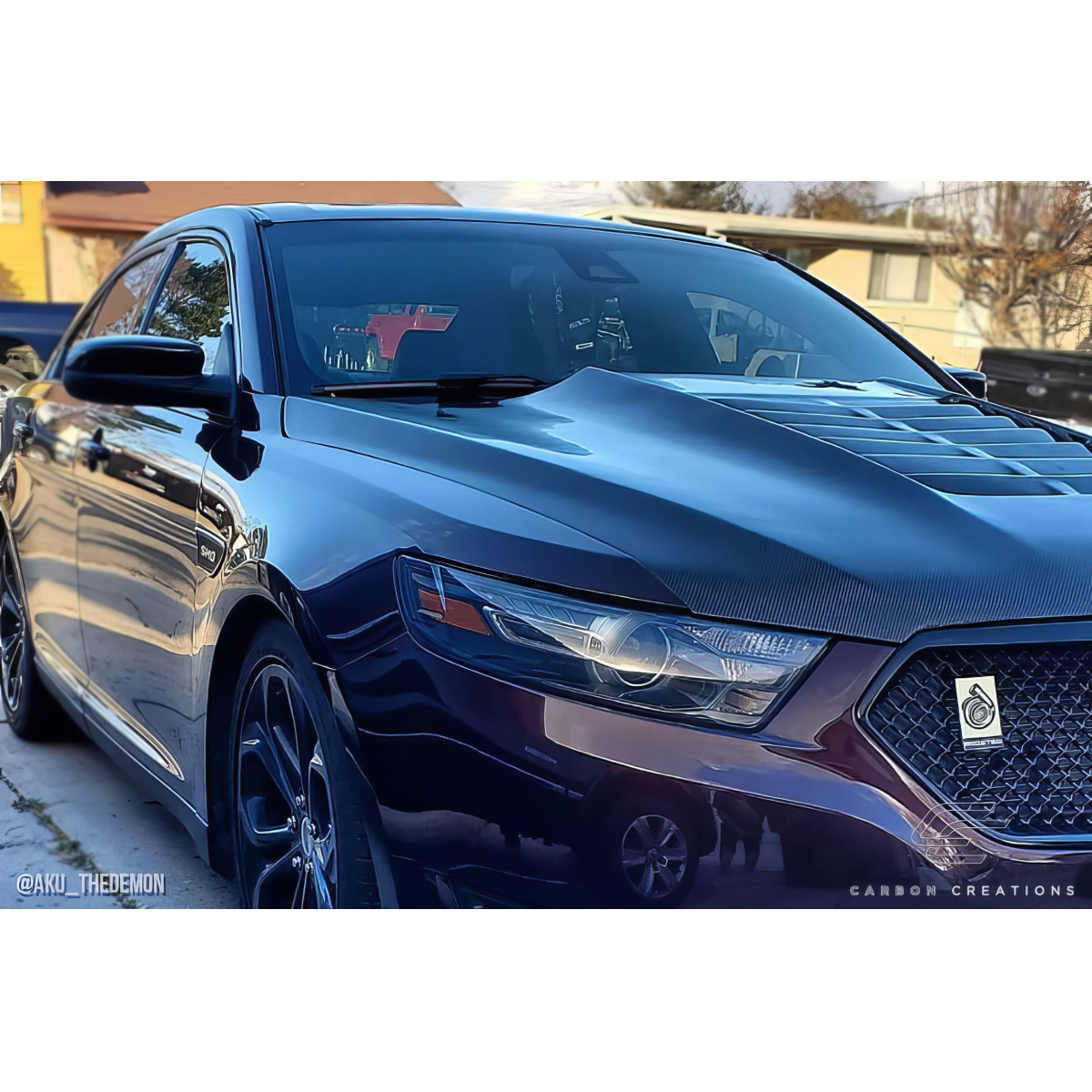 Modify your Ford Taurus 2013 with our Exterior/Hoods - Side angle view showcasing carbon fiber hood