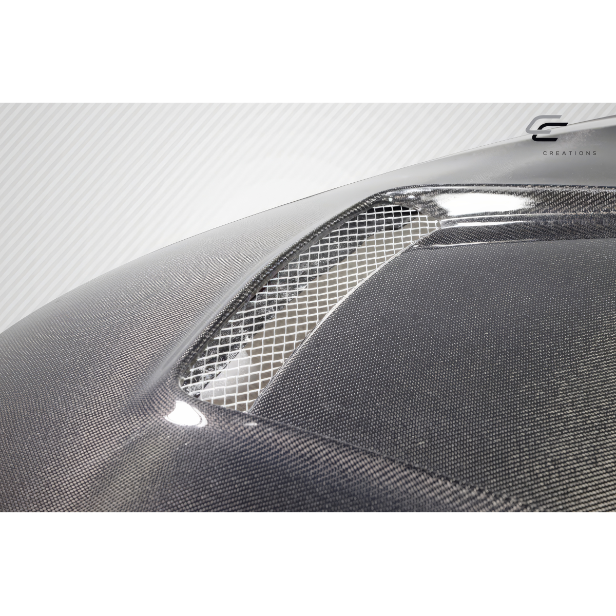 Modify your Toyota Corolla 2014 with our Exterior/Hoods - Angled view showcasing carbon fiber texture