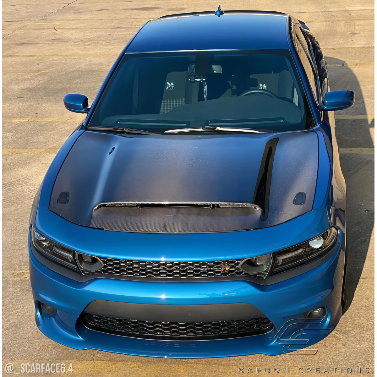 Modify your Dodge Charger 2015 with our Exterior/Hoods - Front view of the vehicle at a slight angle