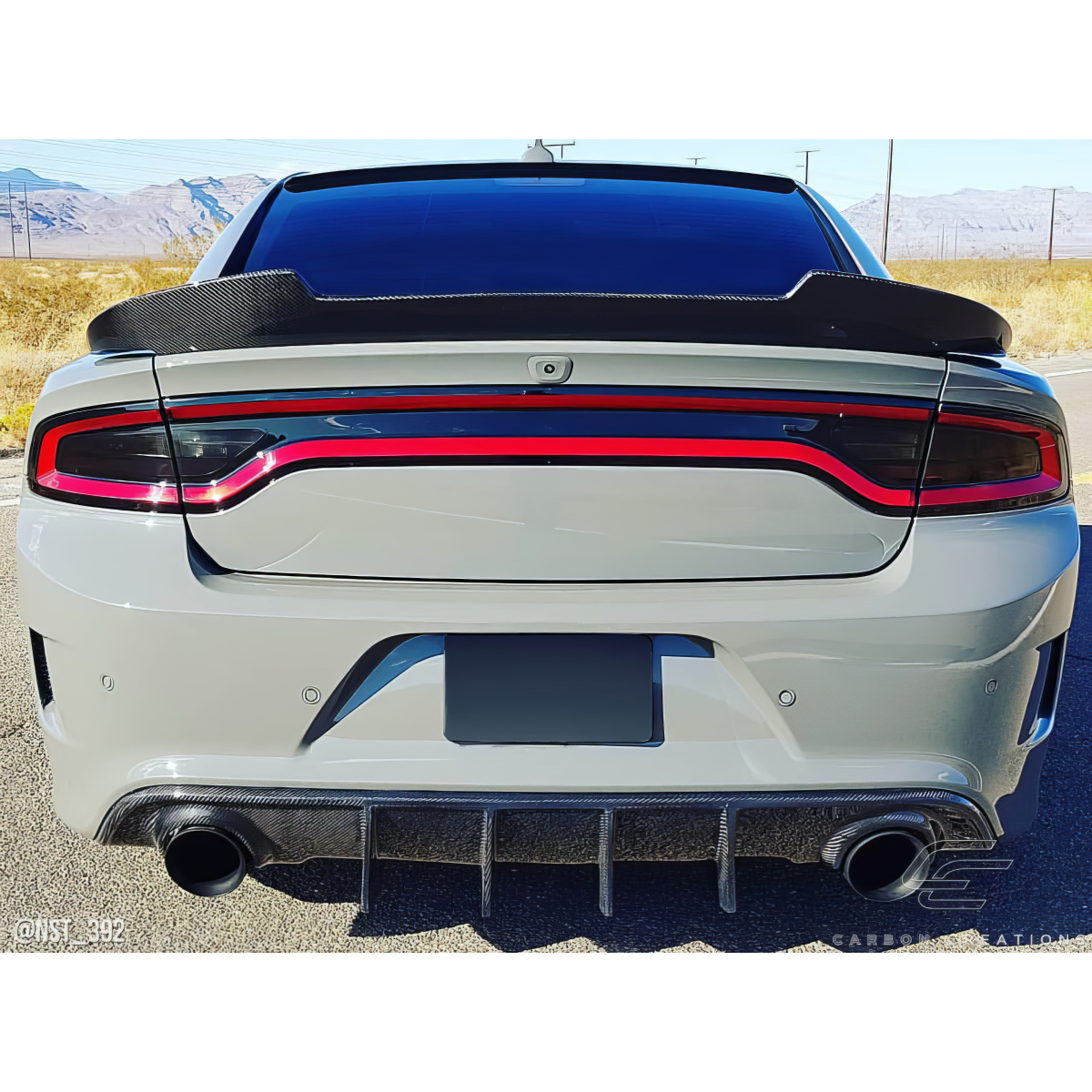 Modify your Dodge Charger 2015 with our Exterior/Wings - Rear view angle of the car showing the spoiler