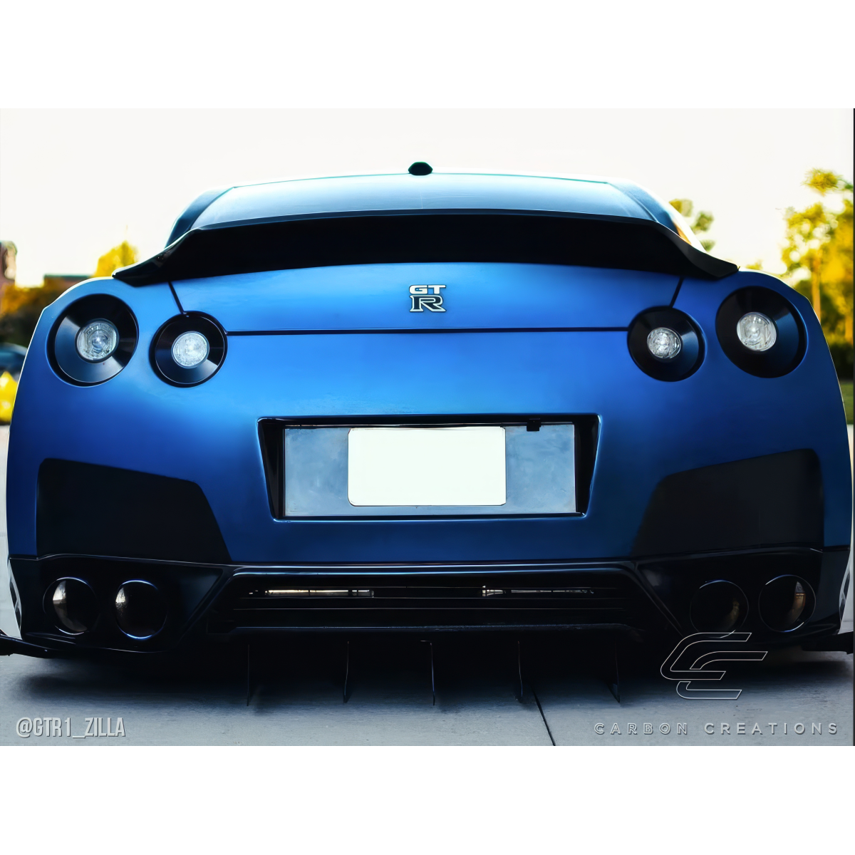 Modify your Nissan GT-R 2009 with our Exterior/Wings - Rear view angle of a blue GT-R vehicle