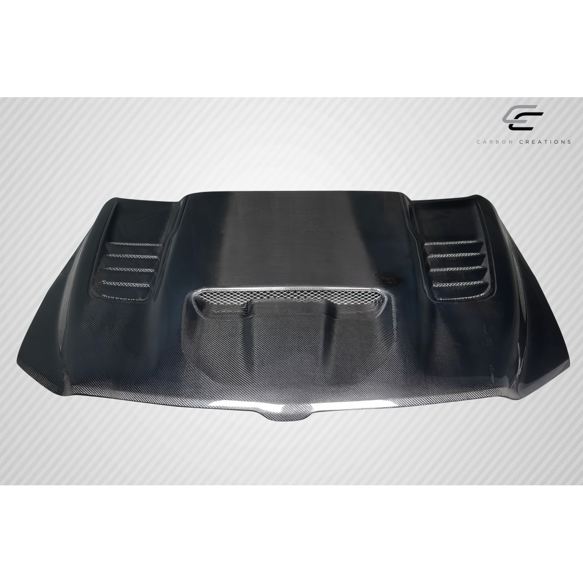 Modify your Dodge Ram 2019 with our Exterior/Hoods - Front view of carbon fiber hood at a slight angle