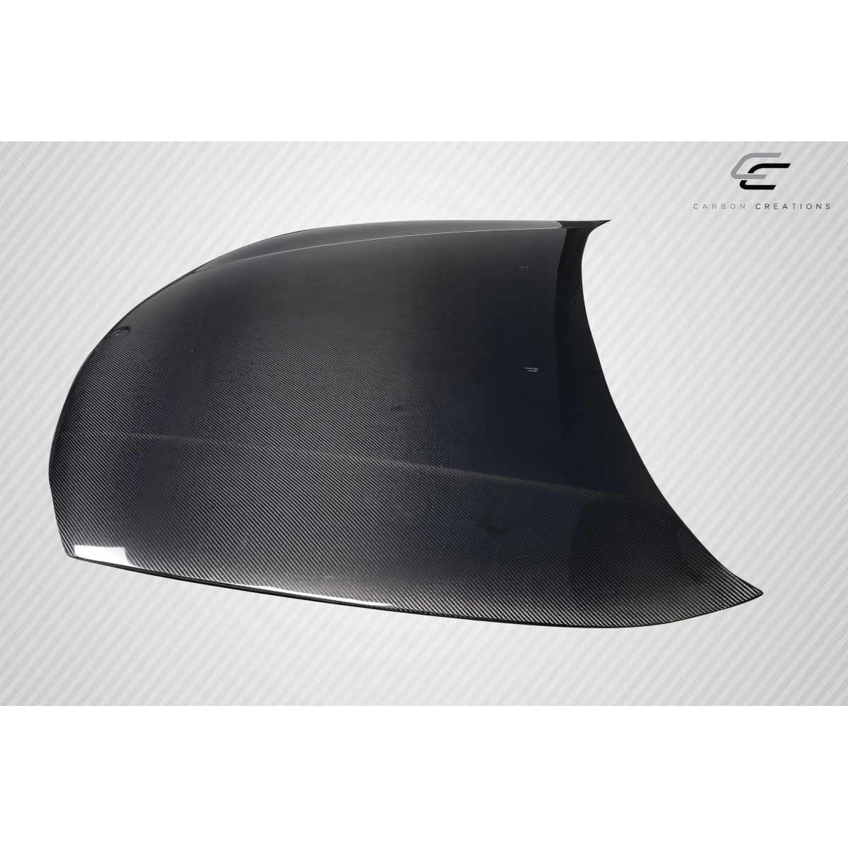 Modify your BMW 1-Series 2008 with our Exterior/Hoods - Angled view showing carbon fiber hood design