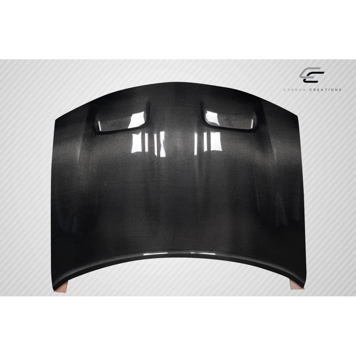 Modify your Dodge Charger 2006 with our Exterior/Hoods - Front view of carbon fiber hood at a slight angle