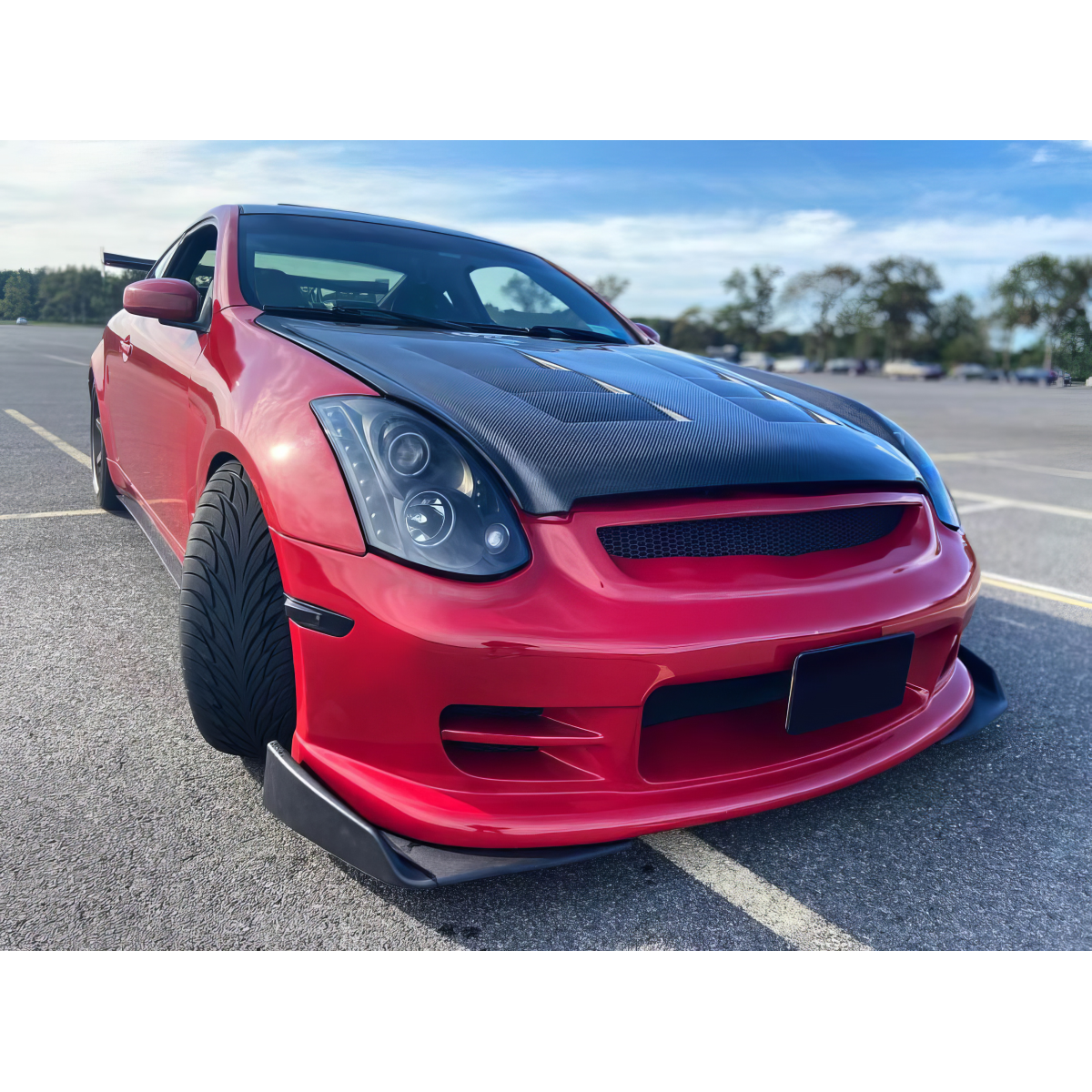 Modify your Infiniti G35 2003 with our Exterior/Hoods - Front low angle view of red Infiniti G35