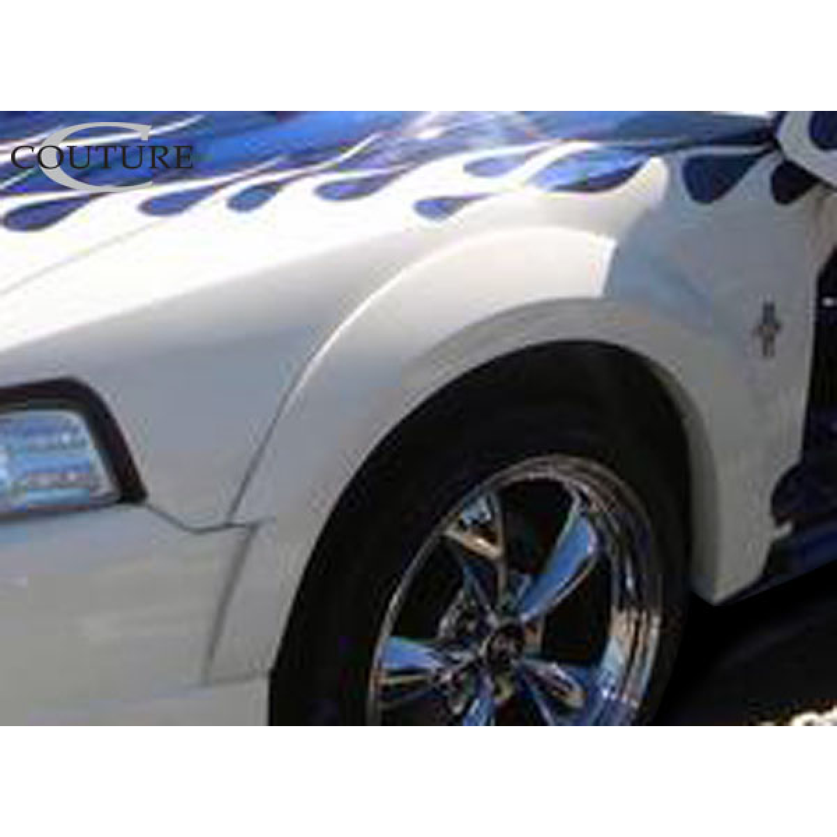 Modify your Ford Mustang 1999 with our Exterior/Fenders - Angled view of front fender and wheel of vehicle