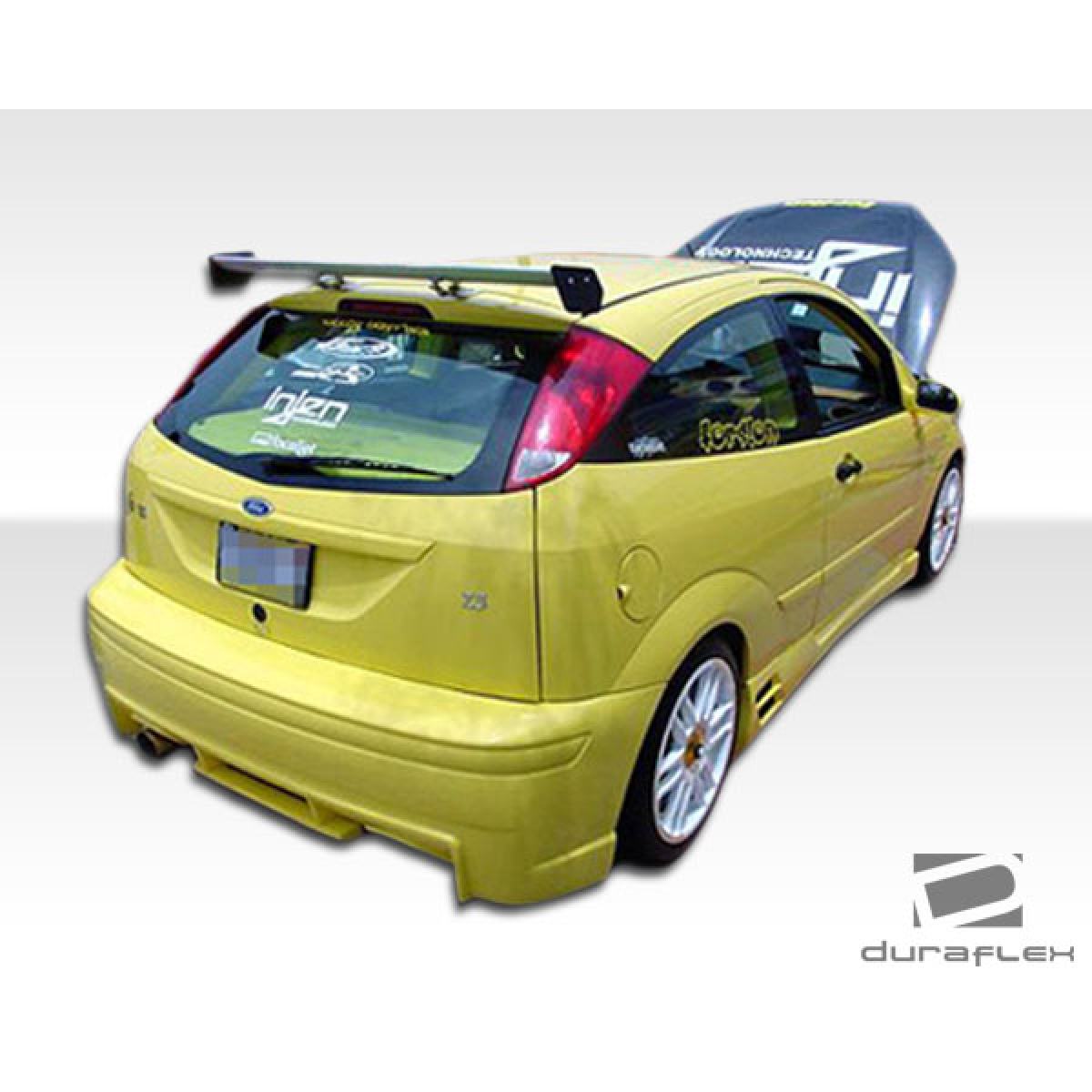 Modify your Ford Focus 2000 with our Exterior/Complete Body Kits - Rear angle showing side skirts of yellow Ford Focus