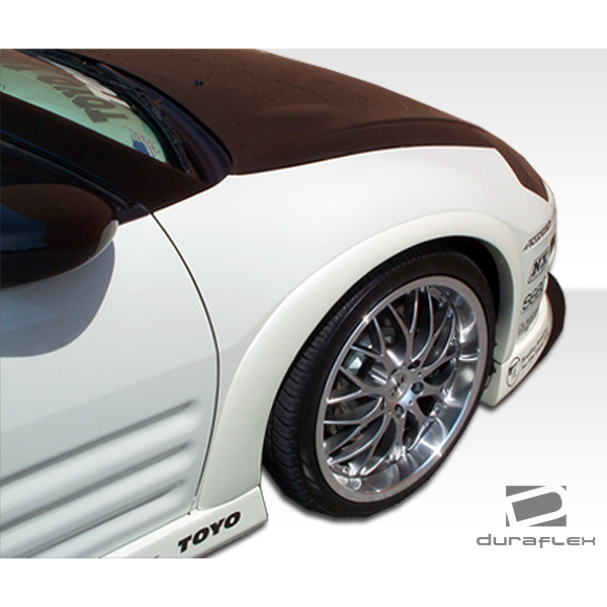 Modify your Mitsubishi Eclipse 2003 with our Exterior/Complete Body Kits - Angled view of the vehicle fender and wheel