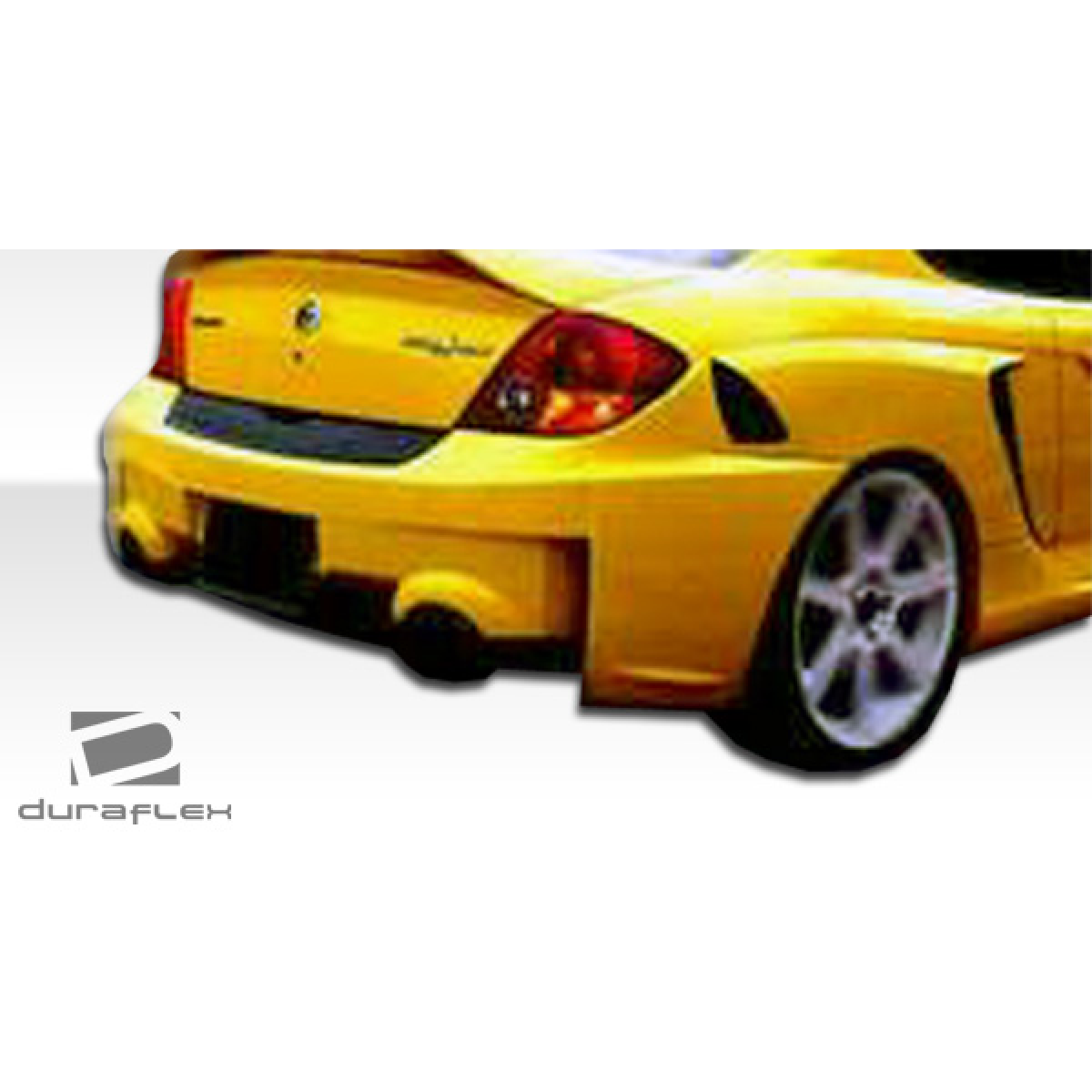 Modify your Hyundai Tiburon 2003 with our Exterior/Rear Bumpers or Lips - Angled view of a rear bumper on a yellow vehicle