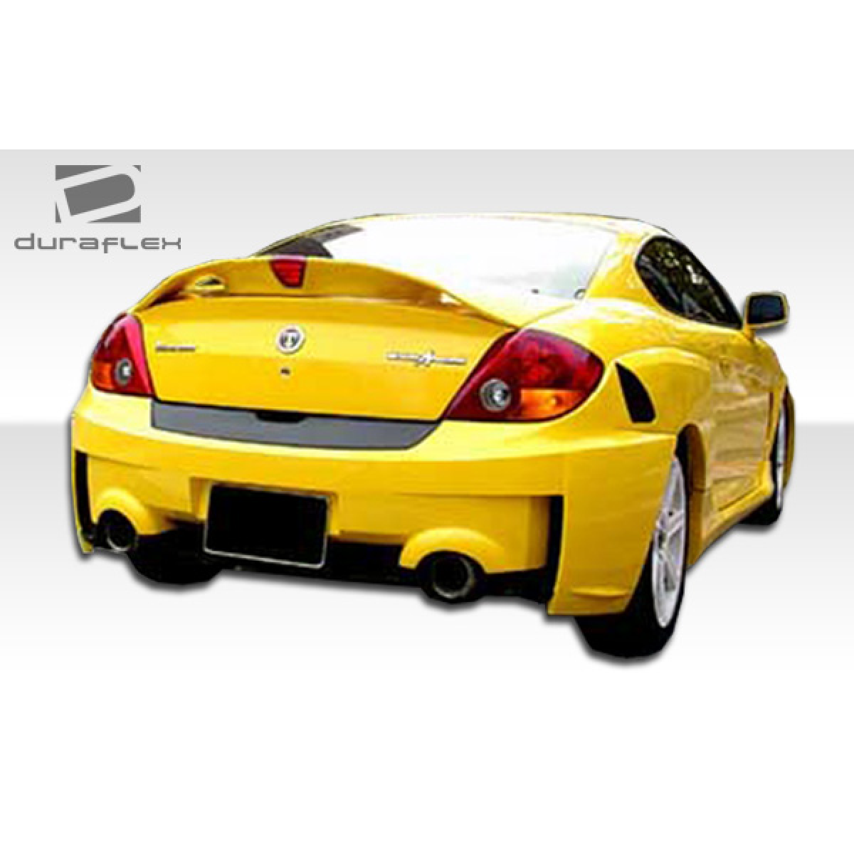 Modify your Hyundai Tiburon 2003 with our Exterior/Rear Bumpers or Lips - View of rear angle showing bumper design