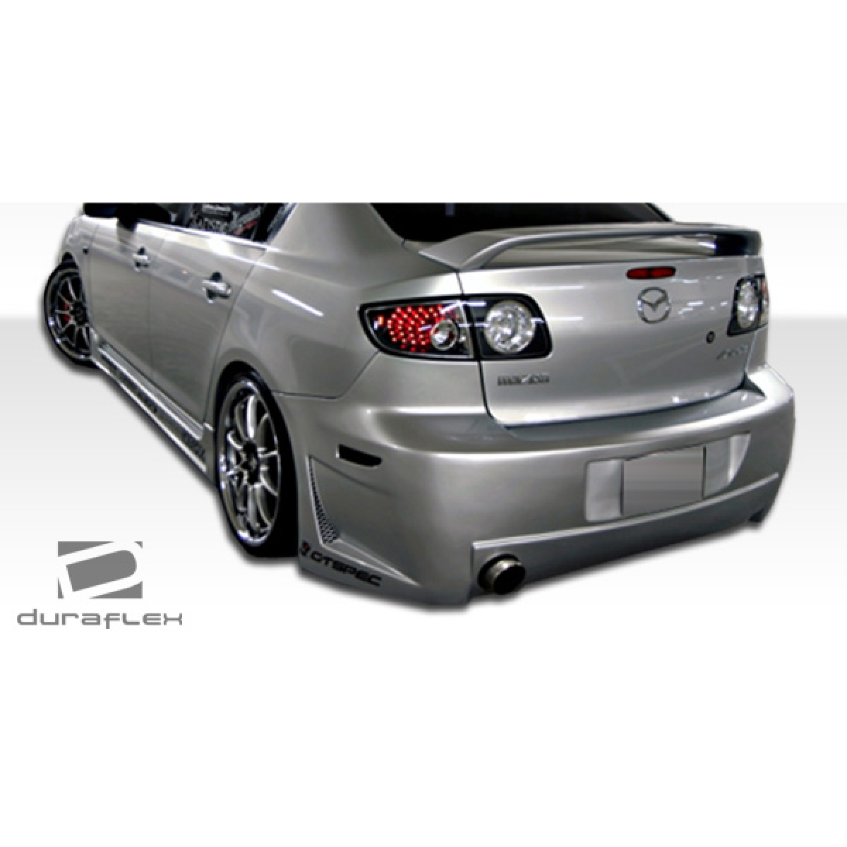 Modify your Mazda 3 2004 with our Exterior/Complete Body Kits - The part is shown at a rear three quarter angle