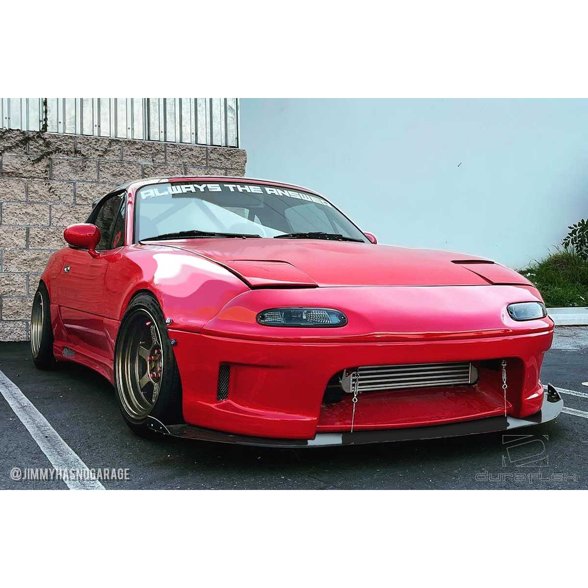 Modify your Mazda Miata 1990 with our Exterior/Front Bumpers or Lips - Front angle view of the vehicle highlights bumper