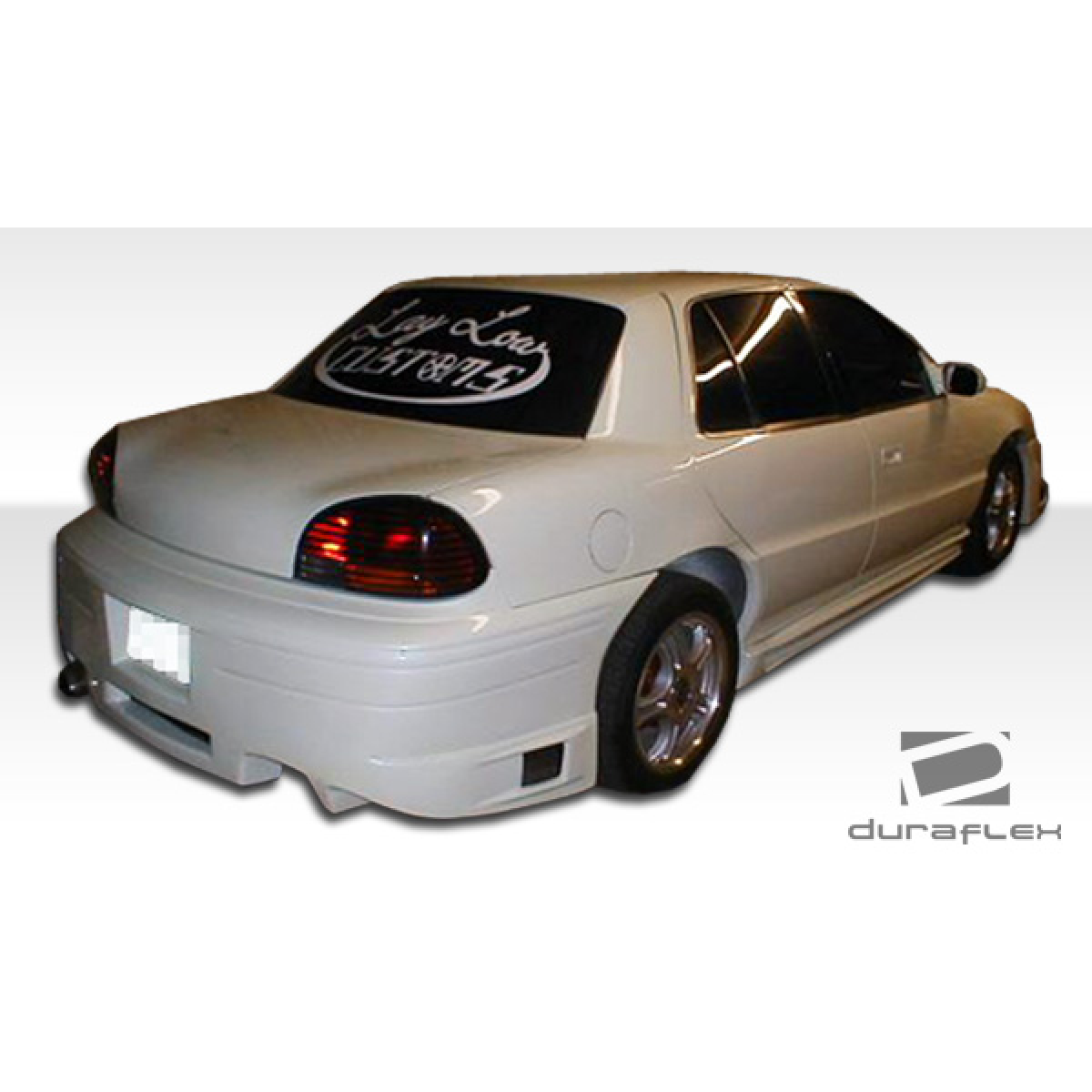 Modify your Pontiac Grand Am 1992 with our Exterior/Side Skirts - Rear angle view of vehicle showcasing side skirts