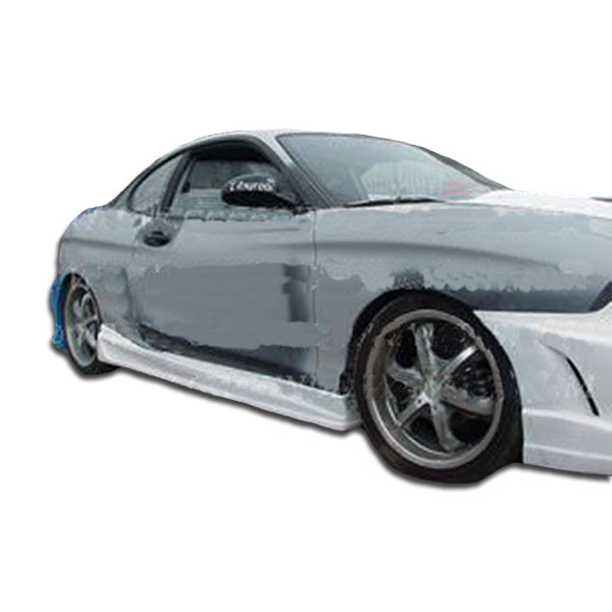 Modify your Hyundai Tiburon 1997 with our Exterior/Side Skirts - Side view of vehicle part at a slight angle