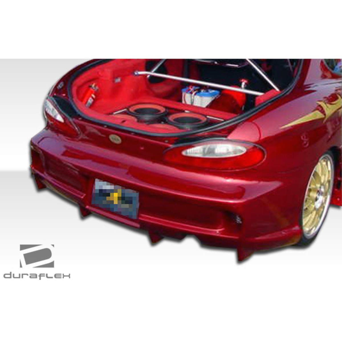 Modify your Hyundai Tiburon 1997 with our Exterior/Rear Bumpers or Lips - Rear angle view of aftermarket bumper installed