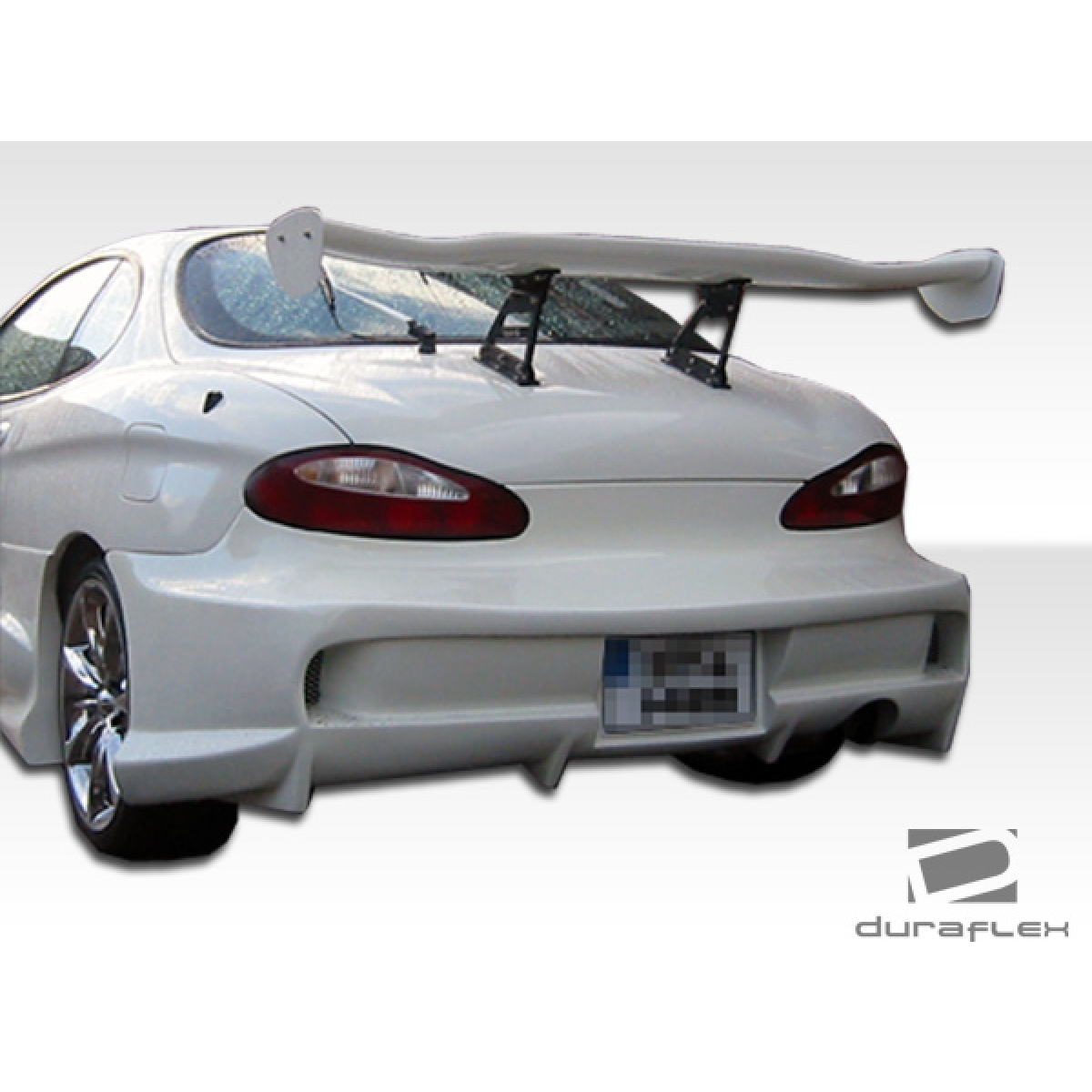 Modify your Hyundai Tiburon 1997 with our Exterior/Rear Bumpers or Lips - Rear view of car from slightly elevated angle