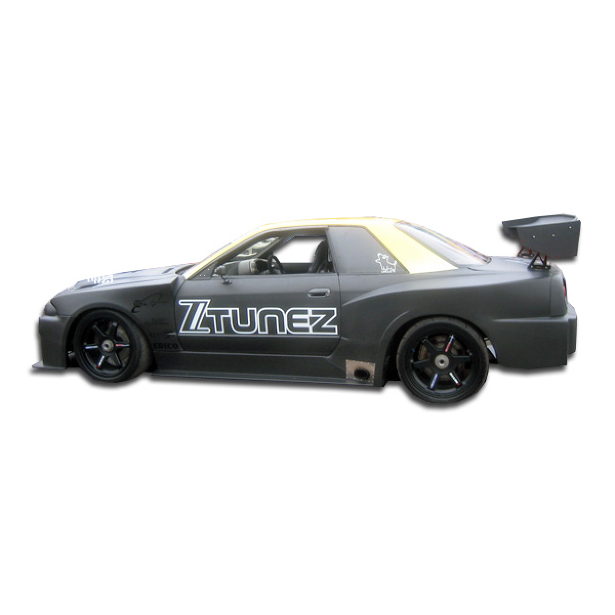 Modify your Nissan Skyline 1989 with our Exterior/Side Skirts - Side view of the vehicle at a lateral angle